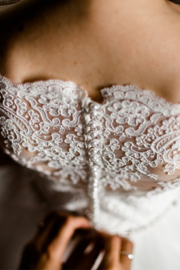 Incredibly up-close view of the lace and buttons going up the back of a gorgeous wedding gown